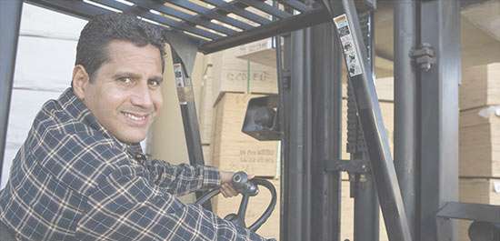 Action Gypsum Supply Services Ordering image closeup of man in a forklift